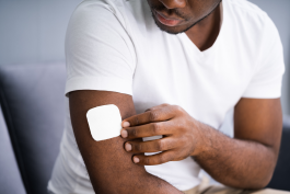 Man applying the Nicotine patch to his upper arm